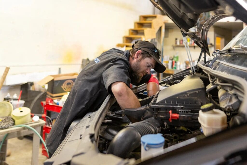 Fleet Pros auto technician performing maintenance of a van