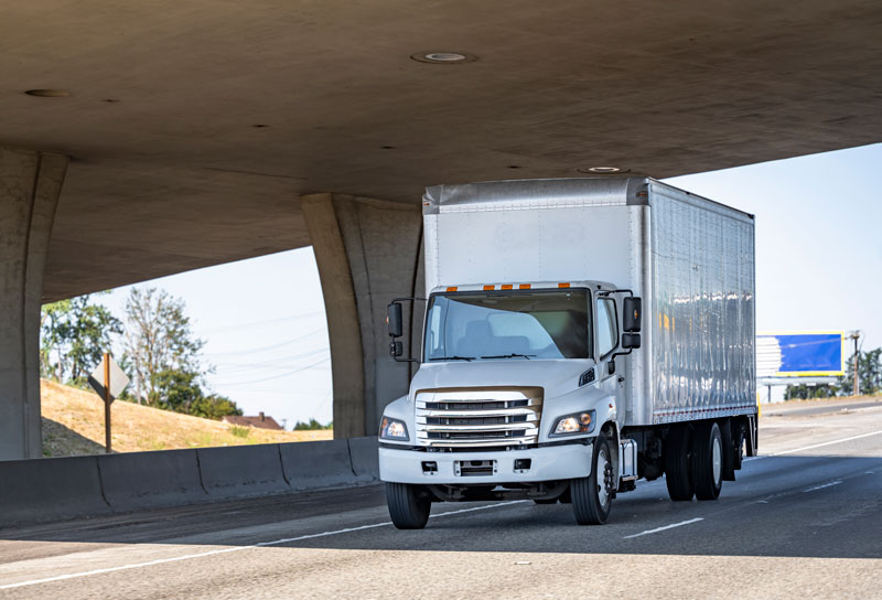 Medium Duty semi driving on the freeway